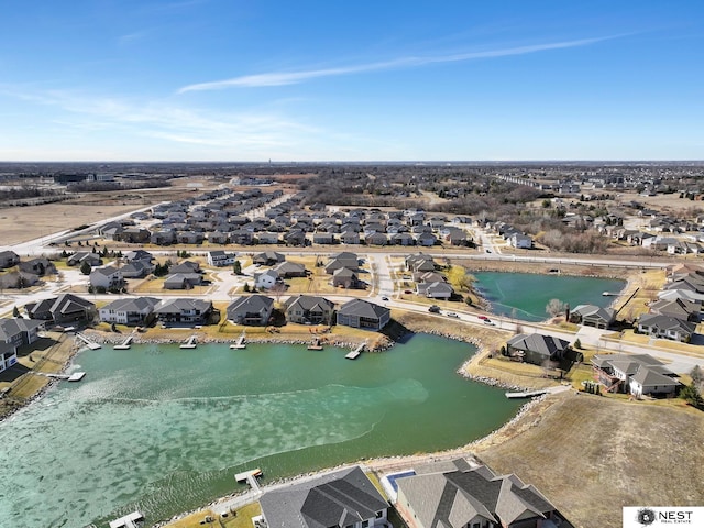 birds eye view of property with a residential view and a water view