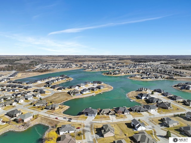 drone / aerial view featuring a water view and a residential view