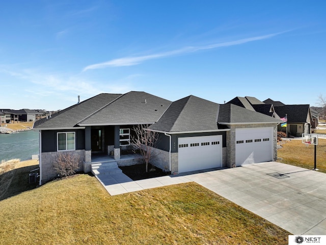 view of front of house featuring an attached garage, stone siding, concrete driveway, and a front yard