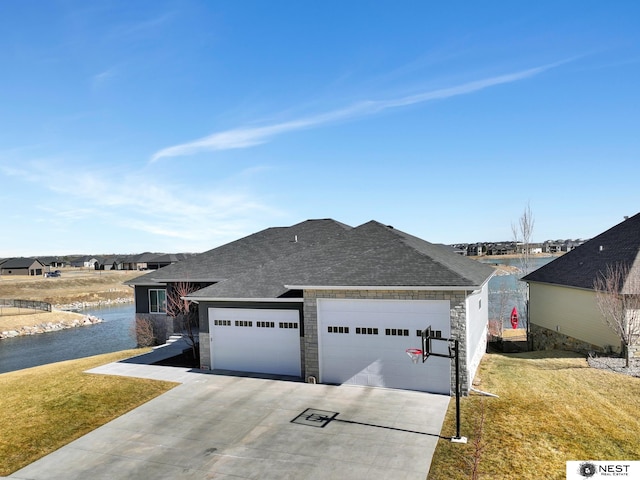 view of front of property with driveway, a front lawn, an attached garage, and stone siding