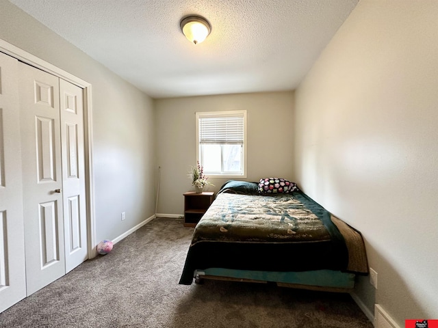 bedroom featuring carpet, a textured ceiling, and baseboards