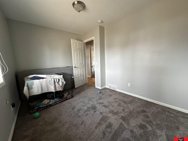 bedroom featuring baseboards, visible vents, and carpet flooring