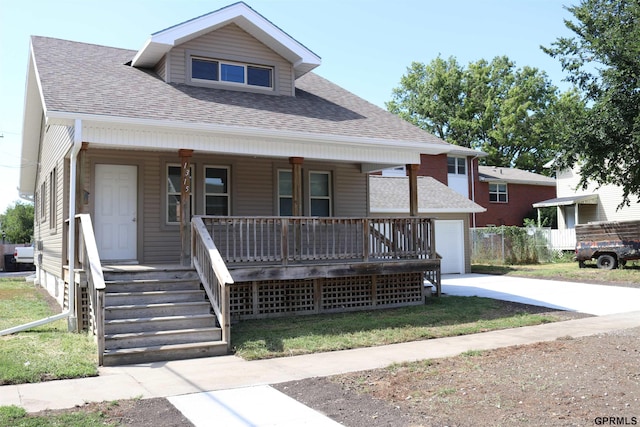 bungalow-style house featuring driveway, covered porch, a garage, and roof with shingles