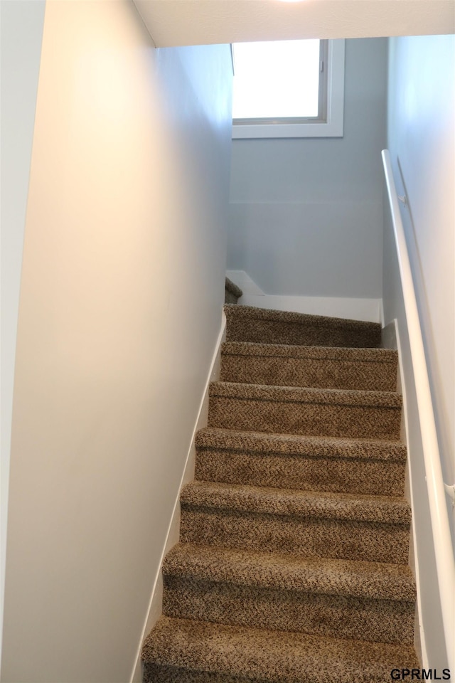 stairs featuring baseboards