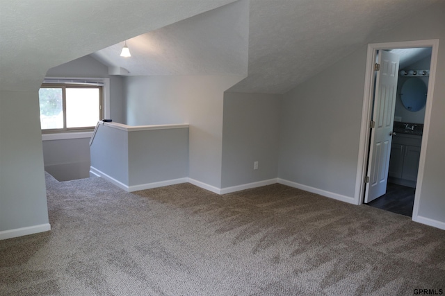 additional living space with lofted ceiling, carpet, and baseboards