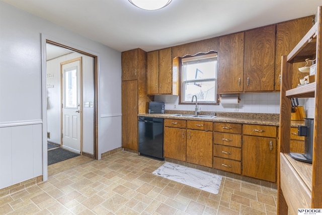 kitchen featuring a sink, tasteful backsplash, brown cabinetry, and dishwasher