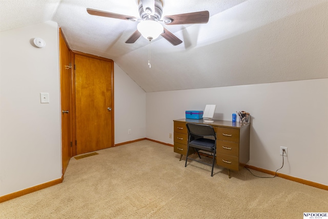 office area with light carpet, vaulted ceiling, and baseboards