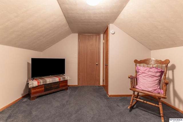 sitting room featuring a textured ceiling, carpet, and baseboards