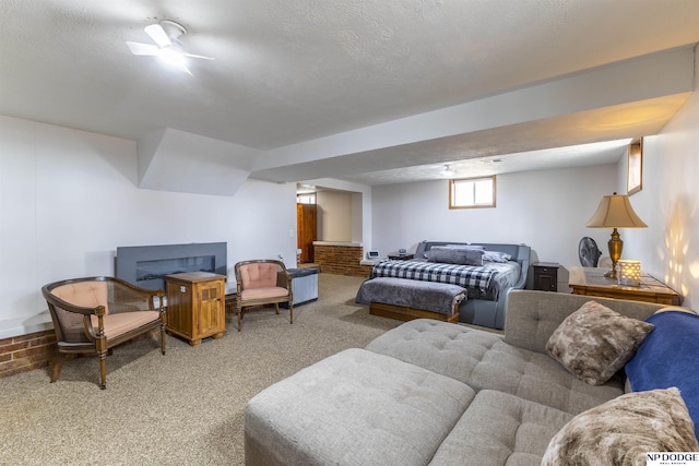 living area featuring carpet floors, a fireplace, and a textured ceiling