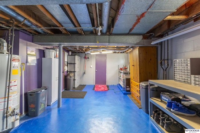 unfinished basement featuring gas water heater and concrete block wall