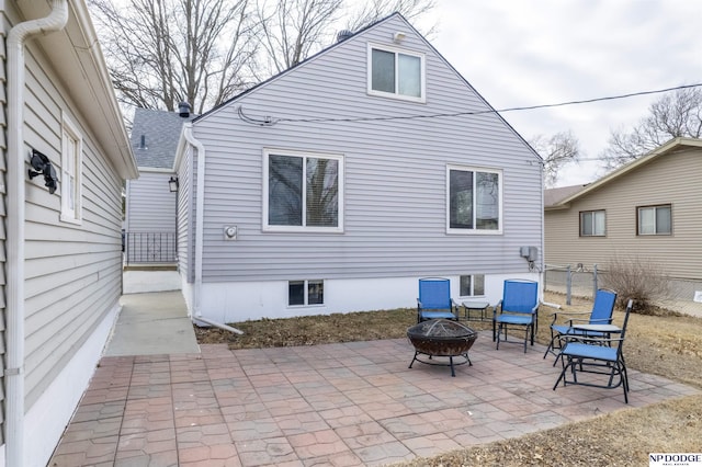 back of house featuring a patio, a fire pit, and fence