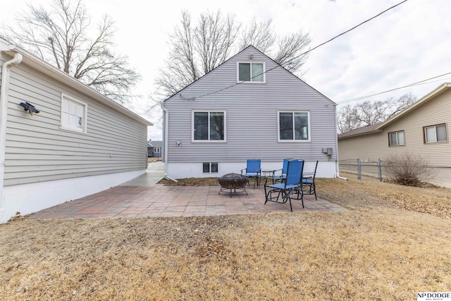 rear view of property featuring fence and a patio