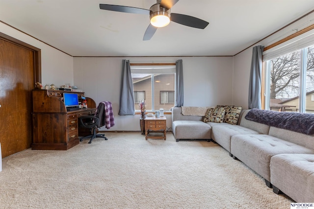 living room featuring carpet floors and a ceiling fan