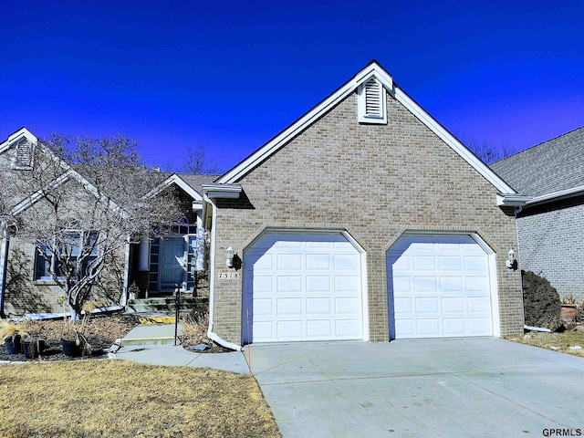 ranch-style house featuring brick siding, driveway, and an attached garage