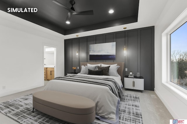 bedroom with a raised ceiling, light carpet, and baseboards