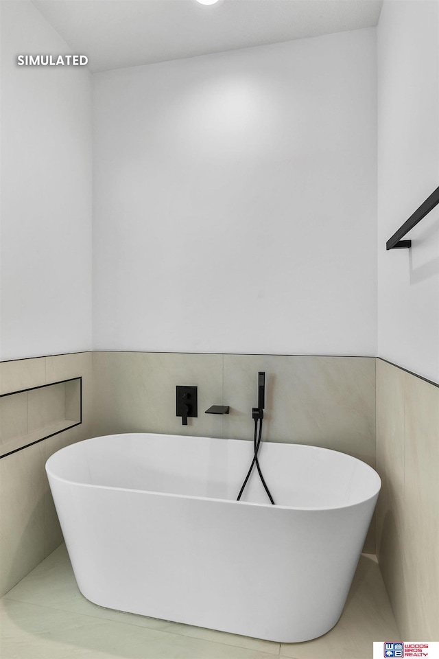 bathroom with a freestanding tub, wainscoting, and tile walls