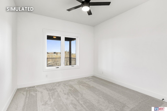 carpeted spare room with baseboards, visible vents, and a ceiling fan