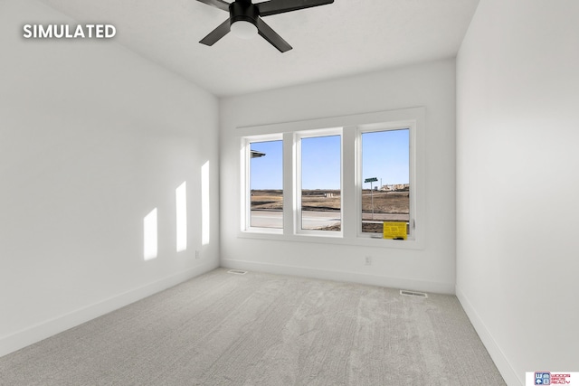 unfurnished room with carpet floors, visible vents, baseboards, and a ceiling fan