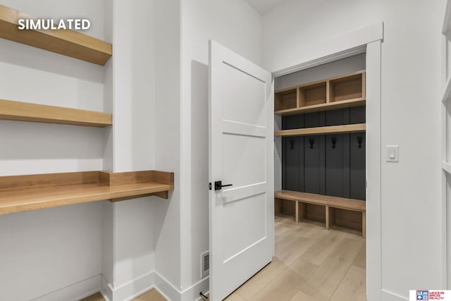 mudroom with visible vents, light wood-style flooring, and baseboards