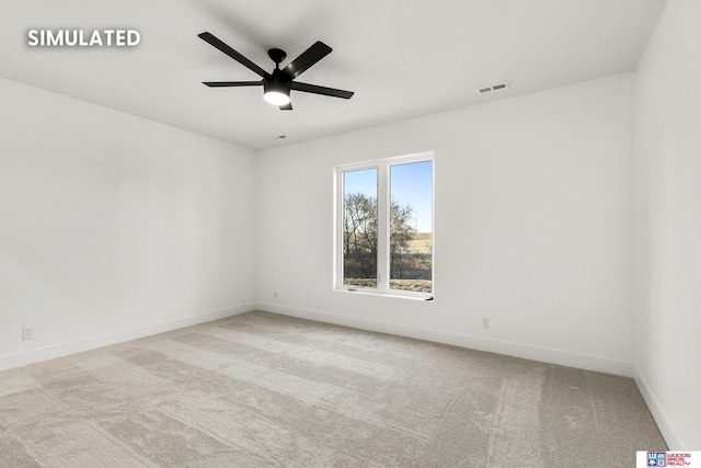 spare room with a ceiling fan, carpet, visible vents, and baseboards