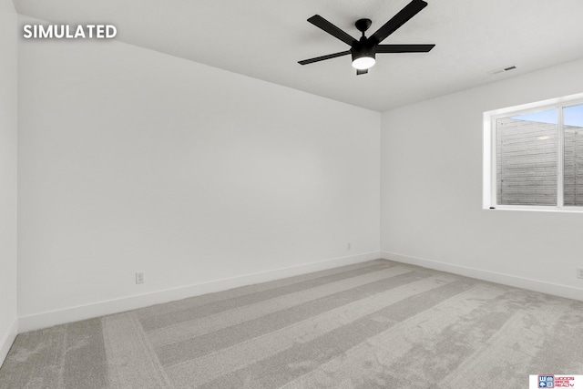 carpeted empty room featuring a ceiling fan, visible vents, and baseboards