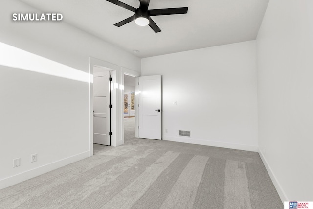 unfurnished bedroom featuring baseboards, visible vents, ceiling fan, and carpet flooring