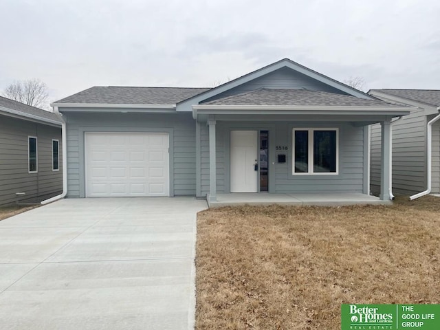 single story home with a porch, a shingled roof, an attached garage, a front yard, and driveway