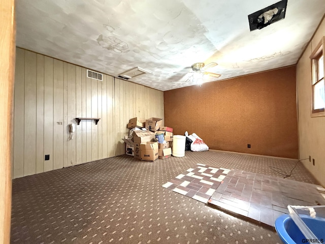 unfurnished room featuring visible vents, carpet, and attic access