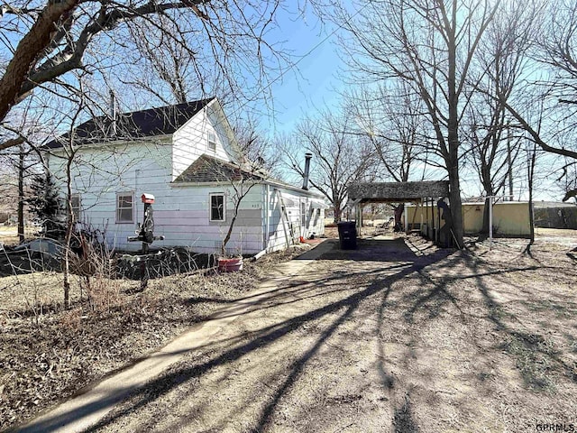 view of side of home with driveway