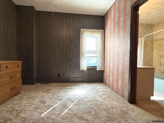 empty room featuring visible vents and carpet flooring