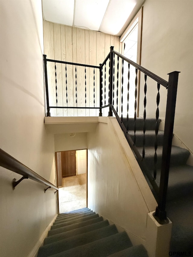 staircase featuring a towering ceiling