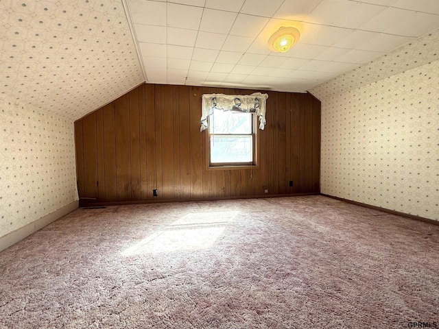 bonus room with carpet, lofted ceiling, baseboards, and wallpapered walls