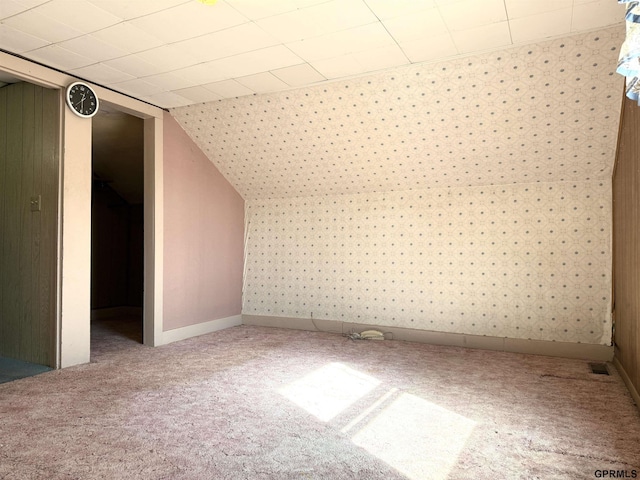 bonus room featuring wallpapered walls, carpet, and baseboards