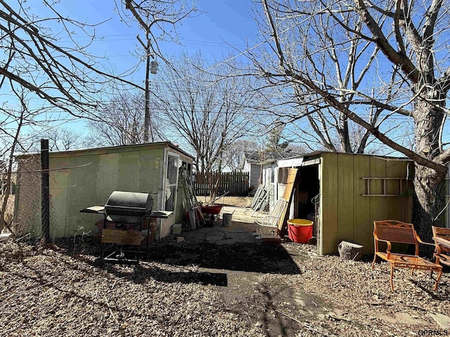 view of yard featuring an outbuilding, fence, and a storage unit