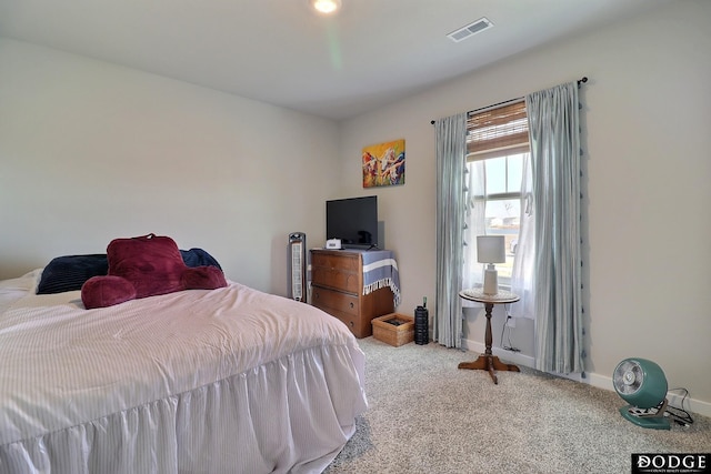 bedroom featuring baseboards, visible vents, and carpet flooring