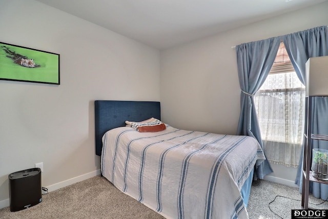 bedroom with carpet and baseboards