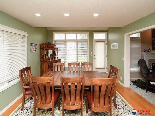 dining room with recessed lighting, light wood-type flooring, and baseboards