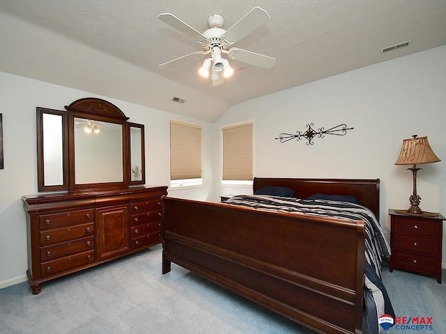 bedroom featuring light carpet, visible vents, and vaulted ceiling