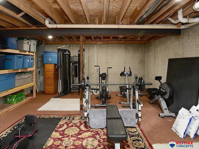 exercise area featuring brick wall