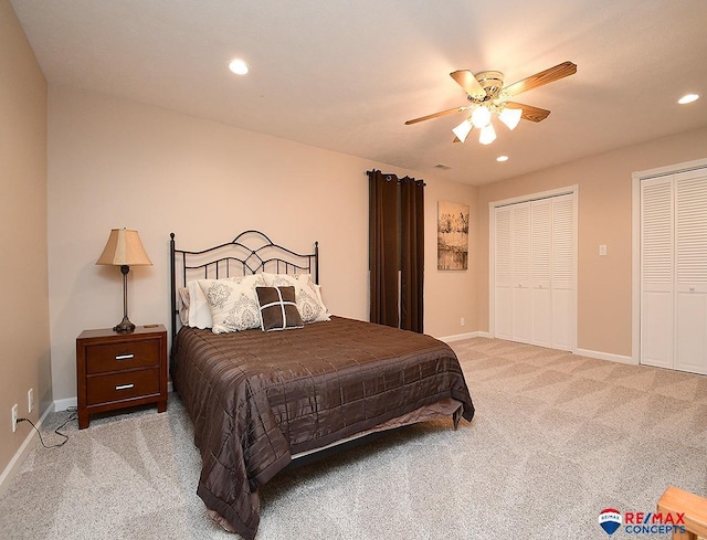 bedroom featuring multiple closets, recessed lighting, light carpet, ceiling fan, and baseboards