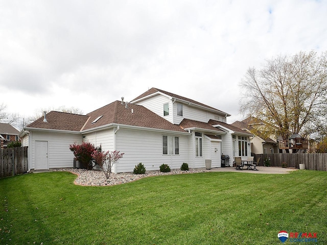 back of house with a patio area, fence, and a yard