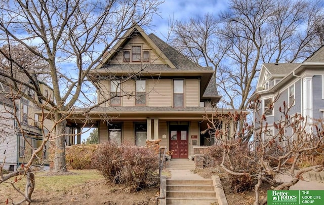 victorian home featuring a porch and roof with shingles