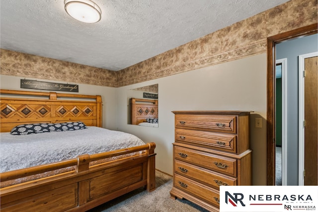 carpeted bedroom featuring a textured ceiling