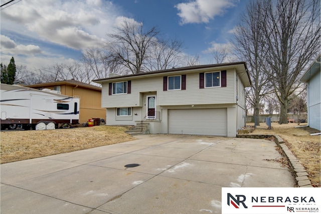 bi-level home with driveway and an attached garage