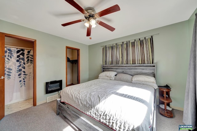 carpeted bedroom featuring visible vents and a ceiling fan