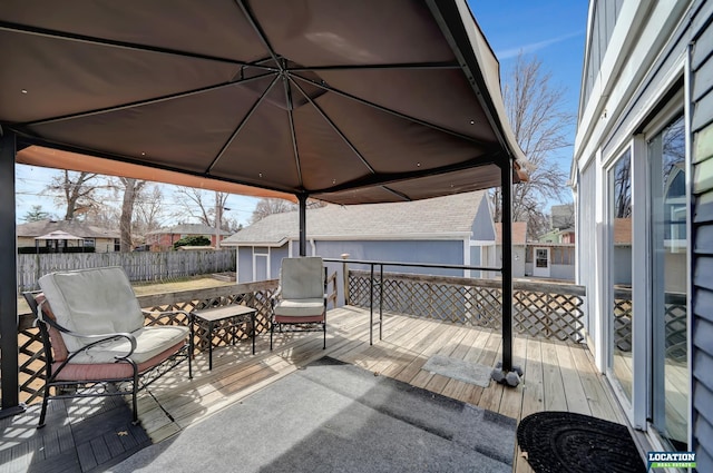 deck with an outbuilding and fence