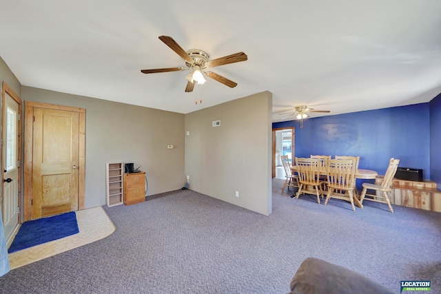 interior space with ceiling fan, carpet, and visible vents