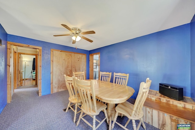 carpeted dining space with ceiling fan