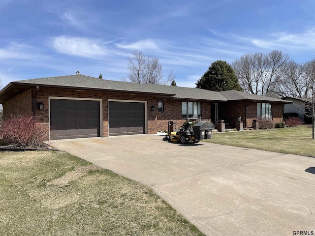 ranch-style home featuring brick siding, a shingled roof, concrete driveway, an attached garage, and a front lawn