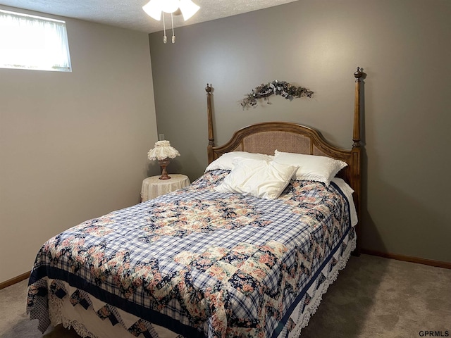 carpeted bedroom with baseboards and a textured ceiling